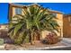 Two-story house with landscaping and a large palm tree at 6228 Wood Stork Ave, Las Vegas, NV 89122