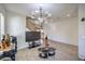 Living room with wood floors, staircase, and large TV at 6228 Wood Stork Ave, Las Vegas, NV 89122