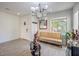 Living room with light wood floors, beige couch, and chandelier at 6228 Wood Stork Ave, Las Vegas, NV 89122