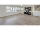 Spacious living room with wood-look floors and large windows at 6228 Wood Stork Ave, Las Vegas, NV 89122