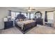 Main bedroom features a large bed, dark wood furniture, and ceiling fan at 6228 Wood Stork Ave, Las Vegas, NV 89122