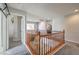 Upstairs hallway with wooden railing and carpet flooring at 6228 Wood Stork Ave, Las Vegas, NV 89122