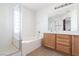 Main bathroom with double vanity, soaking tub, and shower at 6641 Hurkling Stone Ave, Las Vegas, NV 89139