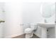 Clean and simple bathroom with pedestal sink and toilet at 6641 Hurkling Stone Ave, Las Vegas, NV 89139