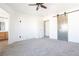 Bright bedroom featuring a sliding barn door and ceiling fan at 6641 Hurkling Stone Ave, Las Vegas, NV 89139