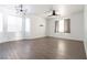 Bright living room with large windows and ceiling fan at 6641 Hurkling Stone Ave, Las Vegas, NV 89139