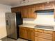 Kitchen with wood cabinets and stainless steel refrigerator at 730 S Royal Crest Cir # 445, Las Vegas, NV 89169