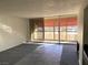 Living room with fireplace, balcony access, and grey carpeting at 730 S Royal Crest Cir # 445, Las Vegas, NV 89169