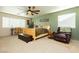 Main bedroom with wood bed frame and ceiling fan at 7317 Wild Roar Ave, Las Vegas, NV 89129