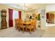 Dining room with a wooden table and view into the living room at 7317 Wild Roar Ave, Las Vegas, NV 89129