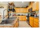 Kitchen with granite countertops, wooden cabinets, and a double sink at 7317 Wild Roar Ave, Las Vegas, NV 89129