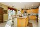 Kitchen with island, wood cabinets, and breakfast nook at 7317 Wild Roar Ave, Las Vegas, NV 89129