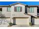 Two-car garage with light-colored doors and landscaping at 7336 N Decatur Blvd # 2, Las Vegas, NV 89131