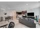 Open living room features a kitchen island, gray couch, and wood-look floors at 7336 N Decatur Blvd # 2, Las Vegas, NV 89131