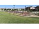 Community pickleball courts with green grass and fencing at 7336 N Decatur Blvd # 2, Las Vegas, NV 89131