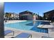 Community pool with lounge chairs and surrounding buildings at 7336 N Decatur Blvd # 2, Las Vegas, NV 89131