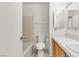 Simple bathroom with beige tile and wood cabinets at 7608 Sea Wind Dr, Las Vegas, NV 89128