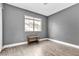 Simple bedroom with wood-look floors and gray walls at 7608 Sea Wind Dr, Las Vegas, NV 89128