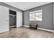 Bedroom with wood-look floors, gray walls, and closet at 7608 Sea Wind Dr, Las Vegas, NV 89128