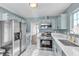 Modern kitchen with stainless steel appliances and light blue cabinets at 7608 Sea Wind Dr, Las Vegas, NV 89128