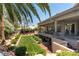 Landscaped backyard with grassy area and raised deck at 7880 Dana Point Ct, Las Vegas, NV 89117