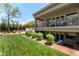 Landscaped backyard featuring a grassy lawn and manicured hedges at 7880 Dana Point Ct, Las Vegas, NV 89117