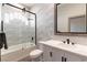 Modern bathroom with a marble vanity, black fixtures, and a sleek glass-enclosed shower at 7880 Dana Point Ct, Las Vegas, NV 89117