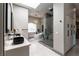 Elegant bathroom with double sink vanity, a soaking tub, and a glass-enclosed shower at 7880 Dana Point Ct, Las Vegas, NV 89117