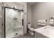 Luxurious bathroom with a modern shower featuring marble tile, pebble floor and sleek fixtures at 7880 Dana Point Ct, Las Vegas, NV 89117
