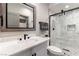 Modern bathroom featuring a vanity with marble countertop and a glass-enclosed shower with stone flooring at 7880 Dana Point Ct, Las Vegas, NV 89117