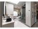 Bright bathroom featuring a glass shower, soaker tub, marble counters, and vessel sinks at 7880 Dana Point Ct, Las Vegas, NV 89117