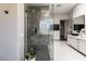 Modern shower with sleek glass enclosure, rainfall shower head, and stone tile flooring at 7880 Dana Point Ct, Las Vegas, NV 89117