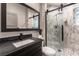 Modern bathroom featuring a sleek vanity and a glass-enclosed shower with marble tile at 7880 Dana Point Ct, Las Vegas, NV 89117