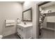 Bathroom with a single vanity, a framed mirror, and a closet area with storage at 7880 Dana Point Ct, Las Vegas, NV 89117