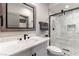 Elegant bathroom featuring a marble vanity, black fixtures, and a beautifully tiled walk-in shower at 7880 Dana Point Ct, Las Vegas, NV 89117