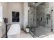 Close up of bathroom featuring a soaker tub and marble walled glass shower at 7880 Dana Point Ct, Las Vegas, NV 89117