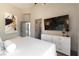 Stylish bedroom featuring sleek furnishings, neutral color palette, and large TV at 7880 Dana Point Ct, Las Vegas, NV 89117