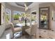 Bright breakfast nook with a glass table and comfortable seating, overlooking the backyard at 7880 Dana Point Ct, Las Vegas, NV 89117