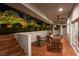 Relaxing covered patio featuring comfortable outdoor seating around a fire table and lush landscaping at 7880 Dana Point Ct, Las Vegas, NV 89117