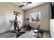 Bright home gym with stationary bike, and weightlifting machine and scenic outdoor views at 7880 Dana Point Ct, Las Vegas, NV 89117