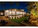 Beautiful backyard featuring manicured lawn and mature trees viewed from an exterior elevation with balconies and terraced steps at 7880 Dana Point Ct, Las Vegas, NV 89117