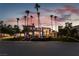 Luxury home exterior at dusk, palm trees, and landscape lighting at 7880 Dana Point Ct, Las Vegas, NV 89117