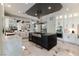 Spacious kitchen with stainless steel appliances, a dark island and white cabinets at 7880 Dana Point Ct, Las Vegas, NV 89117