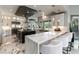 Gourmet kitchen featuring a large island, breakfast bar, and white cabinetry at 7880 Dana Point Ct, Las Vegas, NV 89117