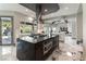 This stunning kitchen features a large island with black granite countertops and stainless steel appliances at 7880 Dana Point Ct, Las Vegas, NV 89117