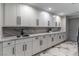 Modern laundry room with white cabinets and marble countertops at 7880 Dana Point Ct, Las Vegas, NV 89117