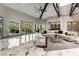 Bright, open living room featuring vaulted ceilings, exposed beams, and marble floors at 7880 Dana Point Ct, Las Vegas, NV 89117