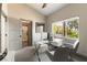 Bright office featuring modern glass desk, serene neutral tones, and view to the outside at 7880 Dana Point Ct, Las Vegas, NV 89117