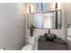 Modern powder room featuring sleek fixtures, custom mirror, and unique sink at 7880 Dana Point Ct, Las Vegas, NV 89117