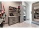 Functional walk-in closet with drawer unit, open shelving, and a door leading to the bathroom at 7880 Dana Point Ct, Las Vegas, NV 89117